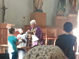 Venice Bishop Frank Dewane distributes Holy Communio at the Ave Maria Oratory assisted by altar boy Joseph Klucik